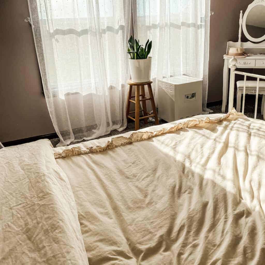 view of bed and EnviroKlenz air purifier in background