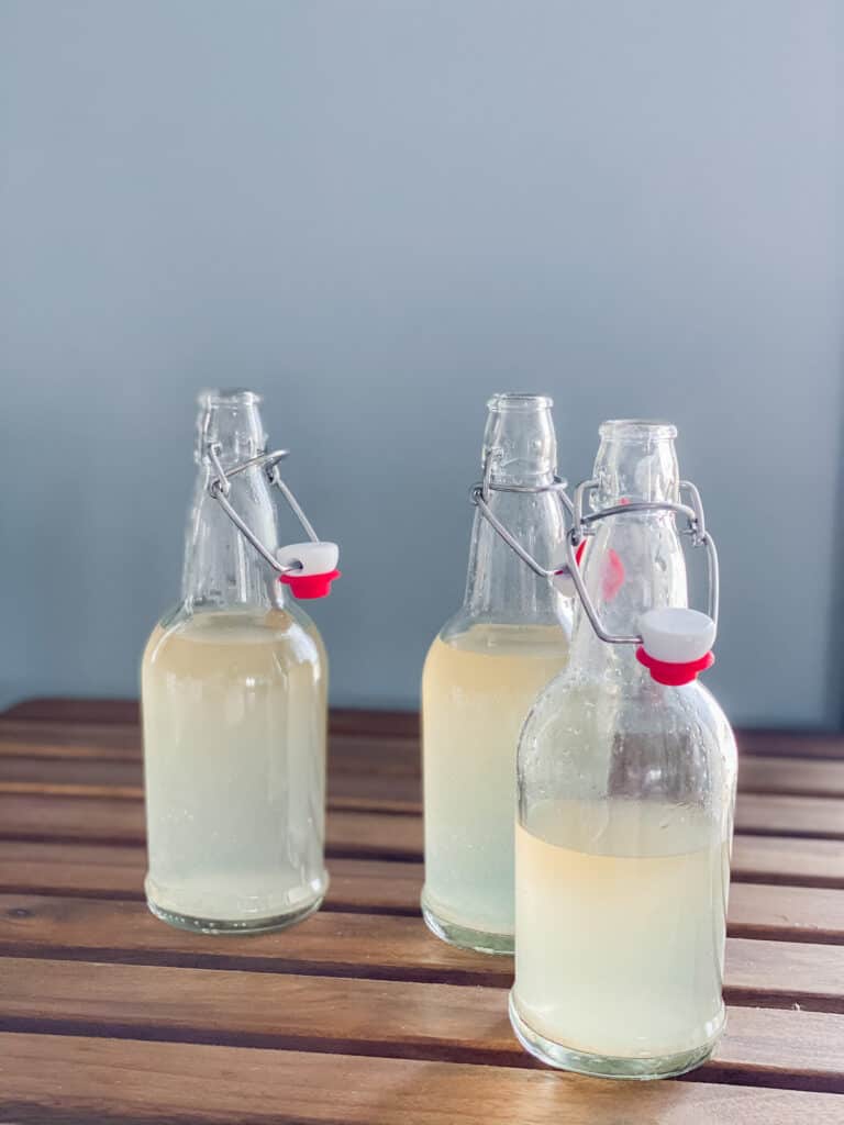 3 flip top bottles with flavored water kefir