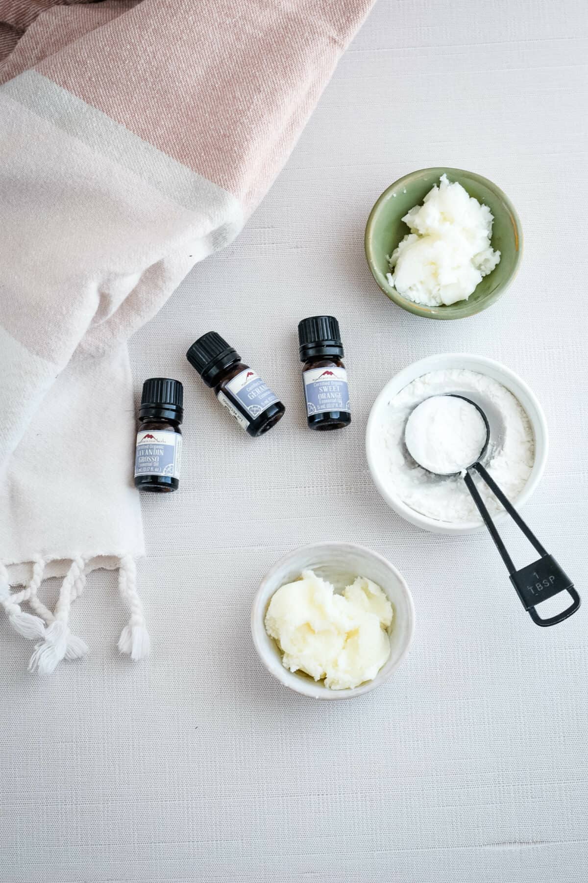 ingredients needed to make this homemade deodorant that actually works in small bowls on the table. 