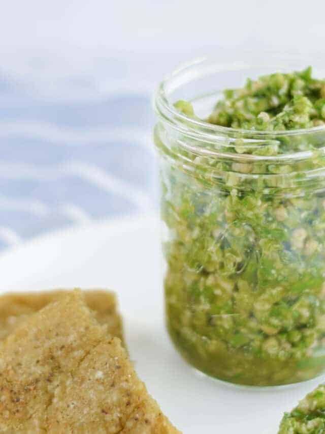 closeup of garlic pesto in a glass jar