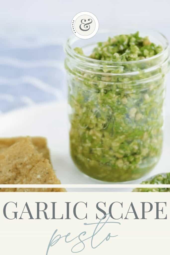 glass jar of the finished pesto on a white tray