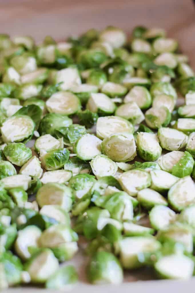 sliced Brussels sprouts on a large baking sheet