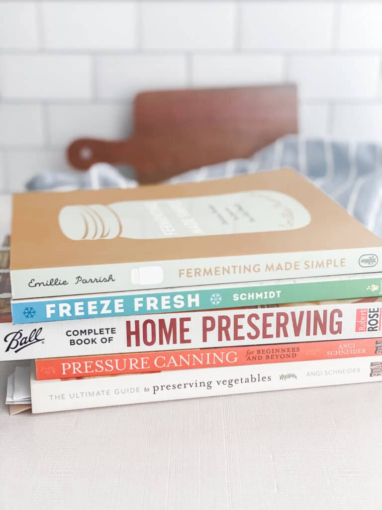 stack of food preservation books on a table.