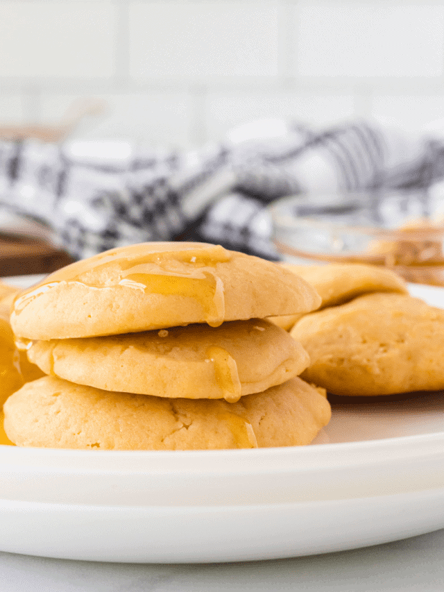 honey butter cookies on a white tray with honey in background