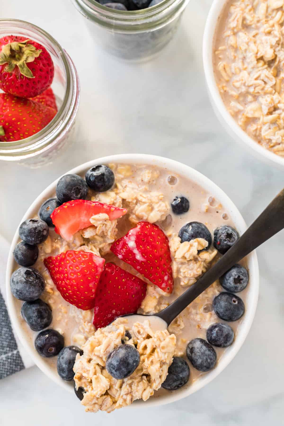 maple overnight oats topped with fresh strawberries and blueberries.