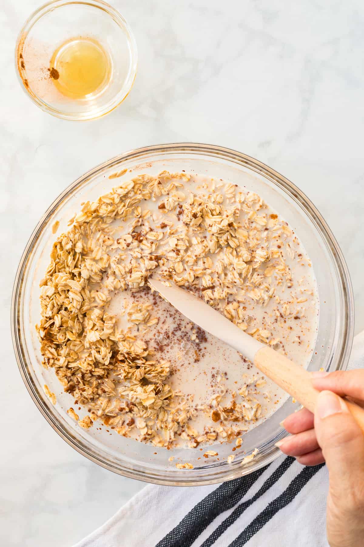 process shot - stirring the overnight oat ingredients in a large bowl with a spatula