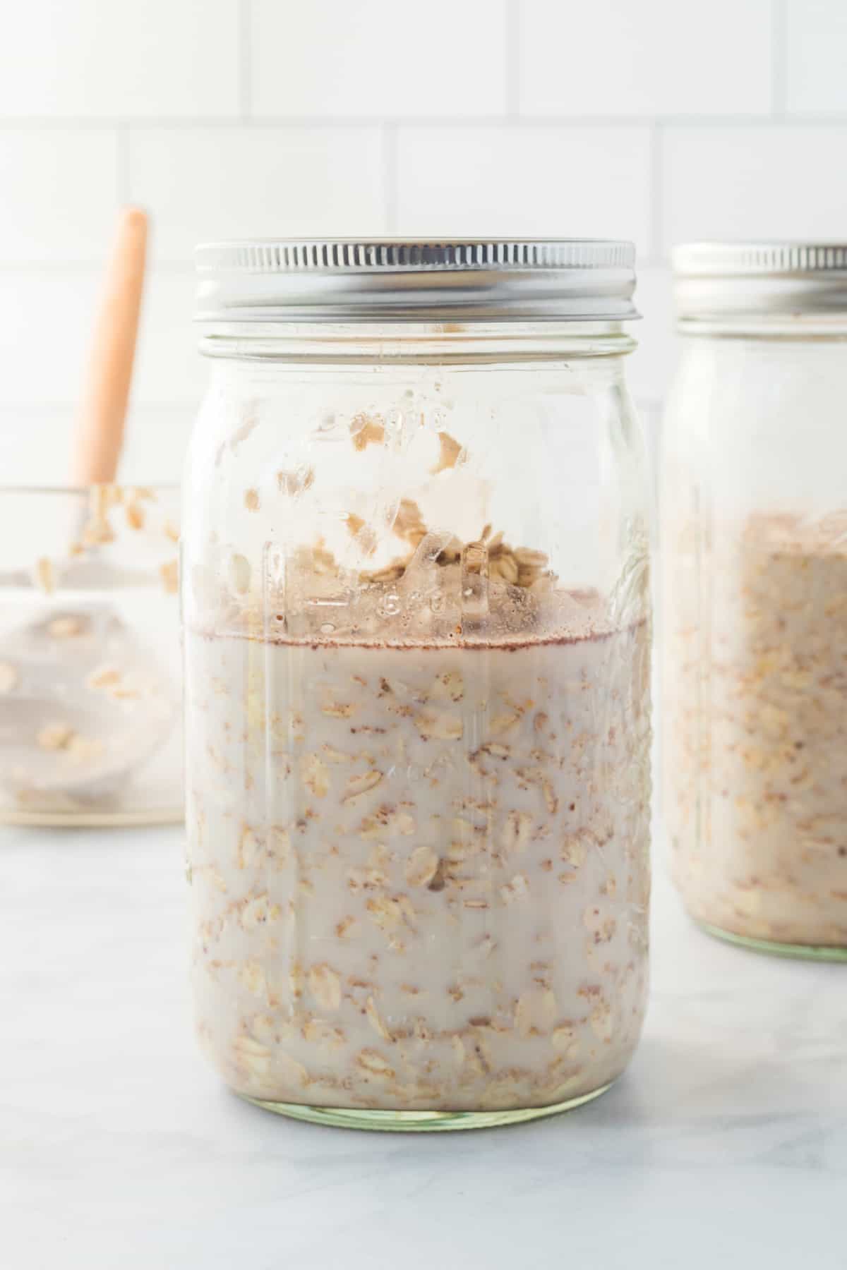 overnight oats ingredients combined and stored in a mason jar with a lid