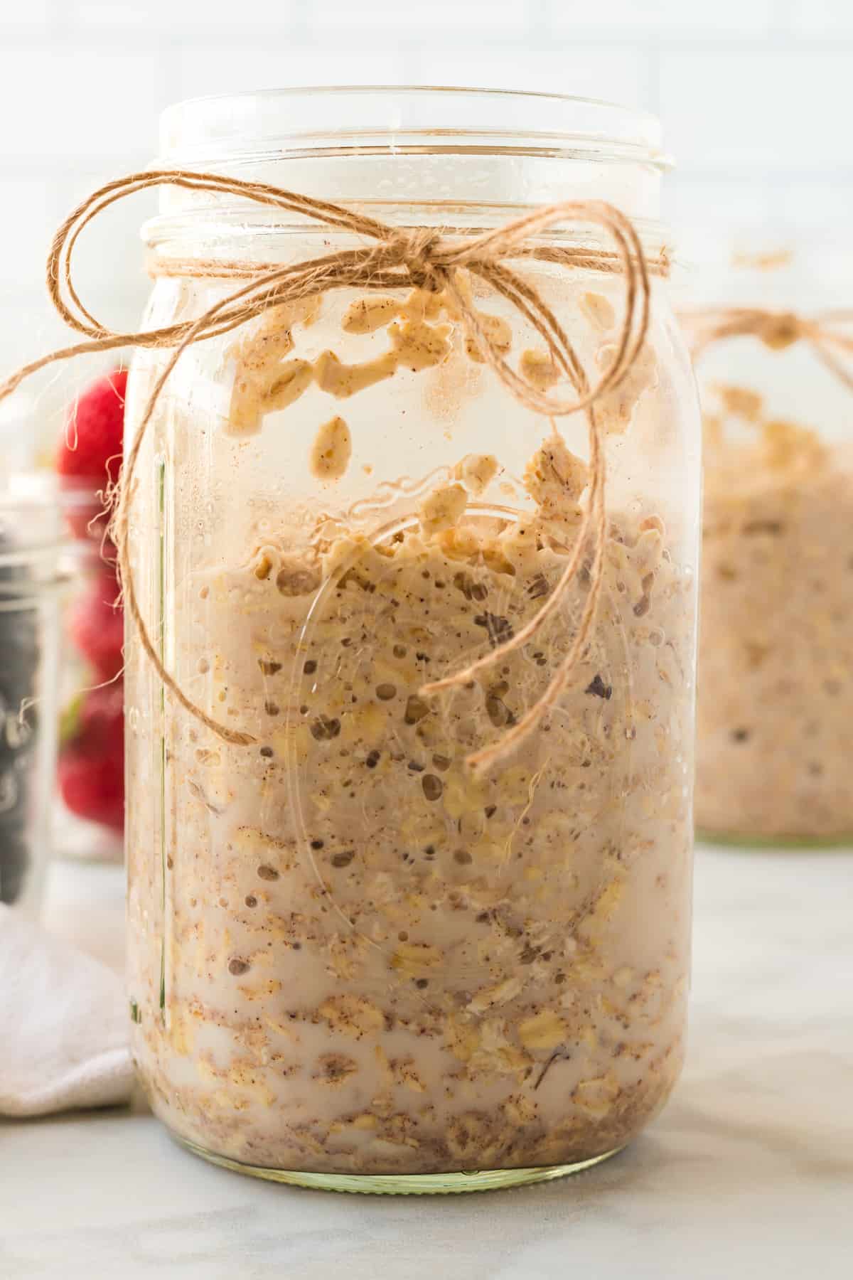 after being in the refrigerator overnight the oats are ready in a large mason jar