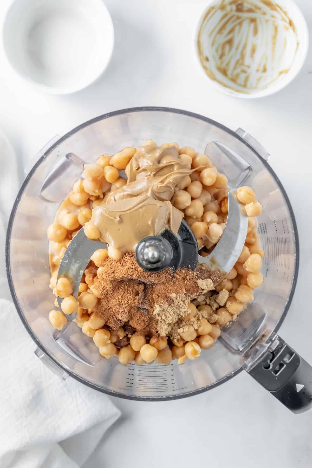 adding the ingredients to the food processor to be blended