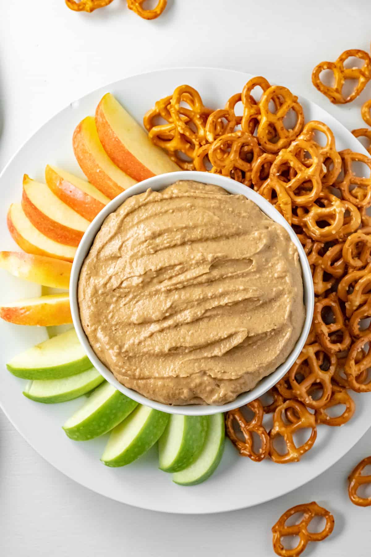white platter with gingerbread hummus, pretzels, and apple slices 