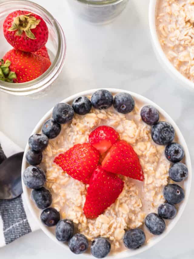 maple overnight oats topped with fresh berries and in white bowls.