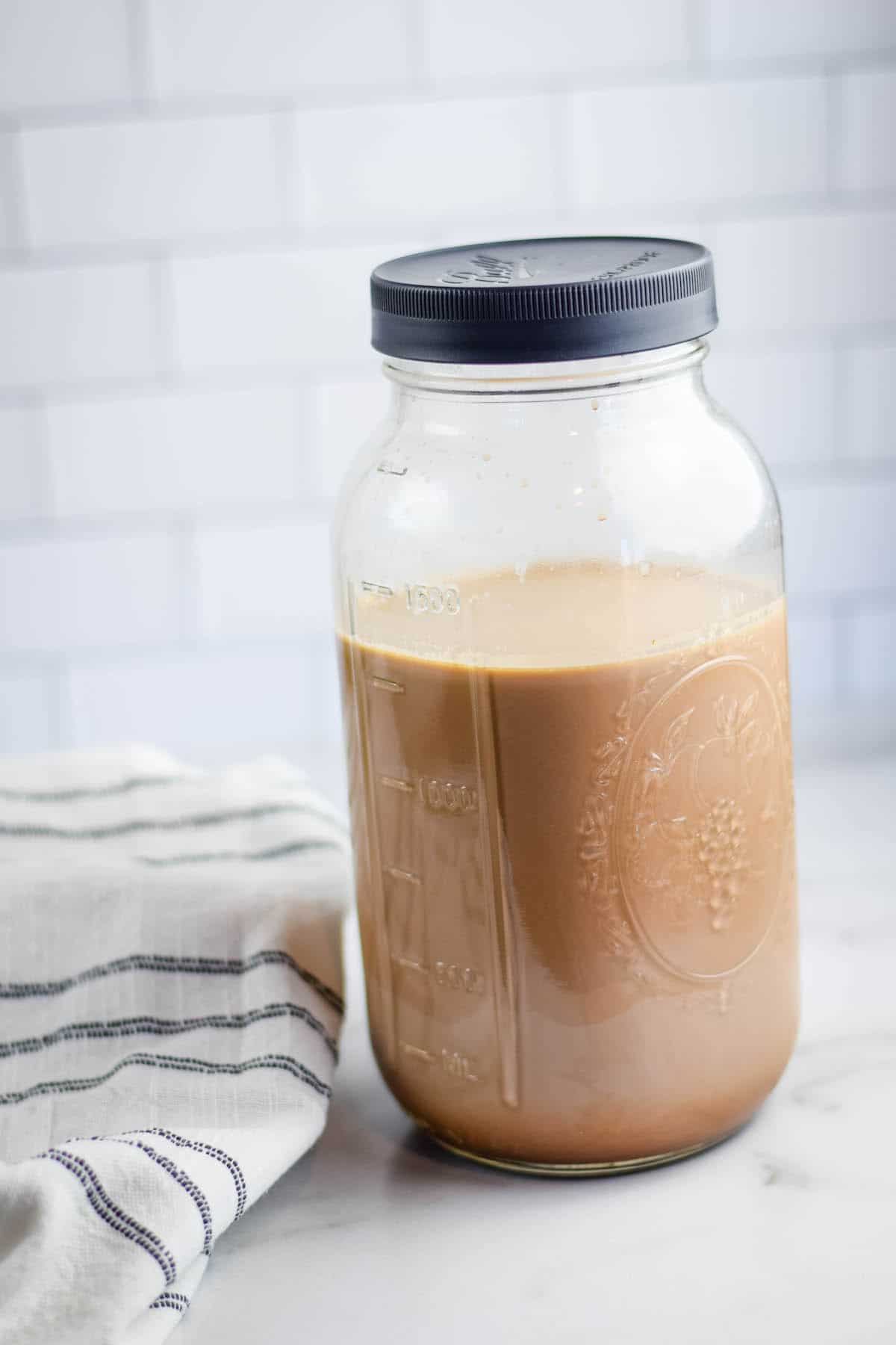 leftover hot chocolate in a large mason jar with a black leak proof lid