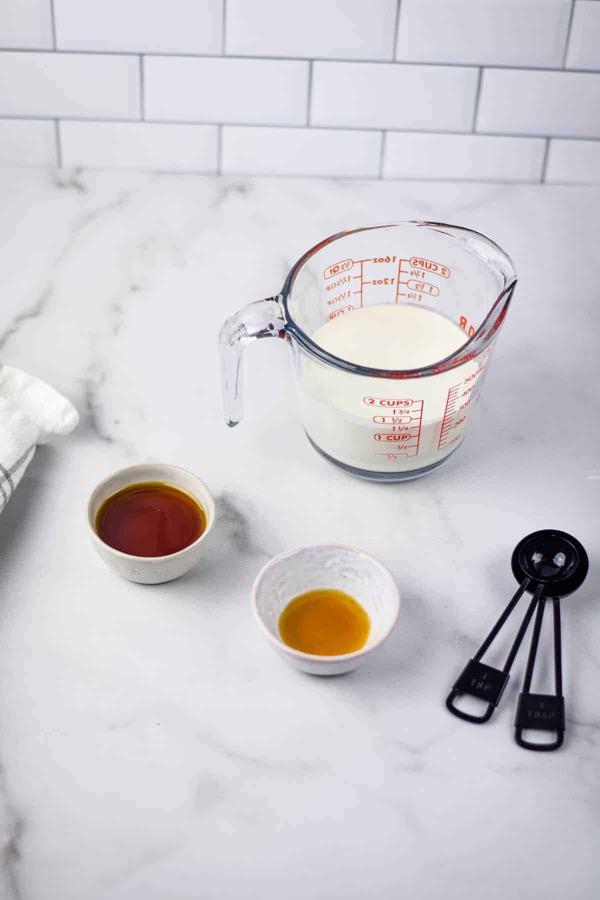 maple whipped cream ingredients in small bowls and measuring spoons