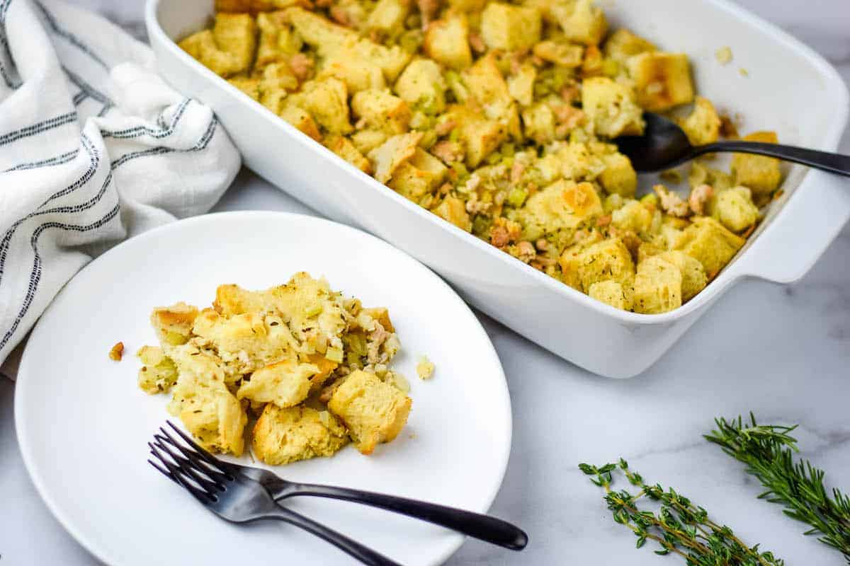 white plates with the stuffing and fresh herbs in the background