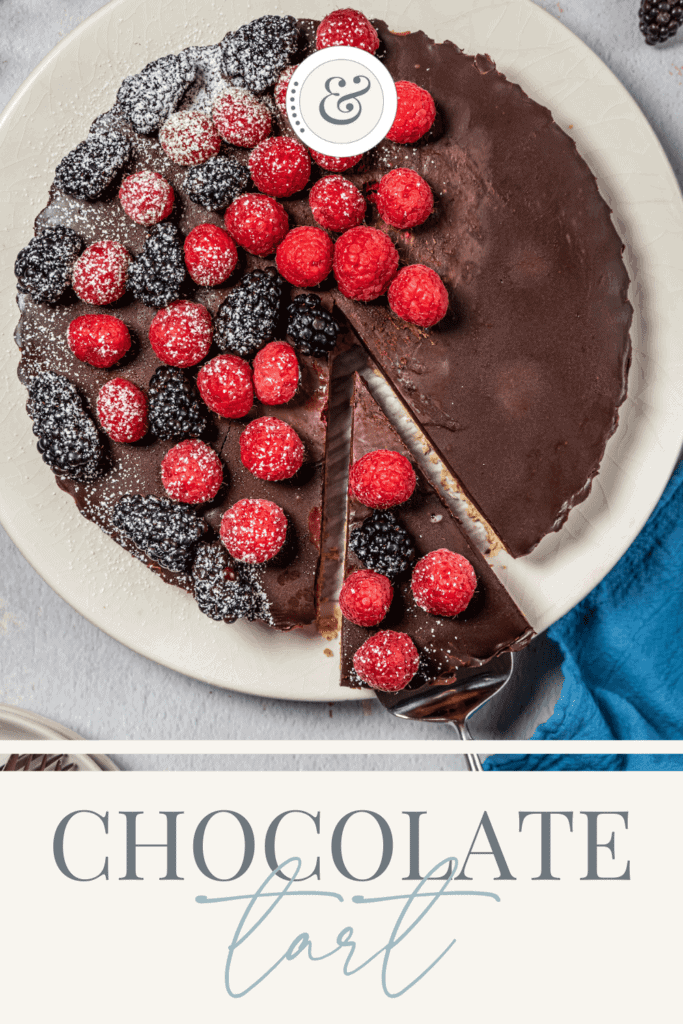 slice of chocolate tart being removed from the tart pan with a serving utensil