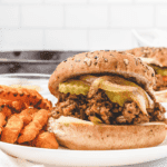 sloppy joes on whole wheat grain bread with sweet potato fries on the side