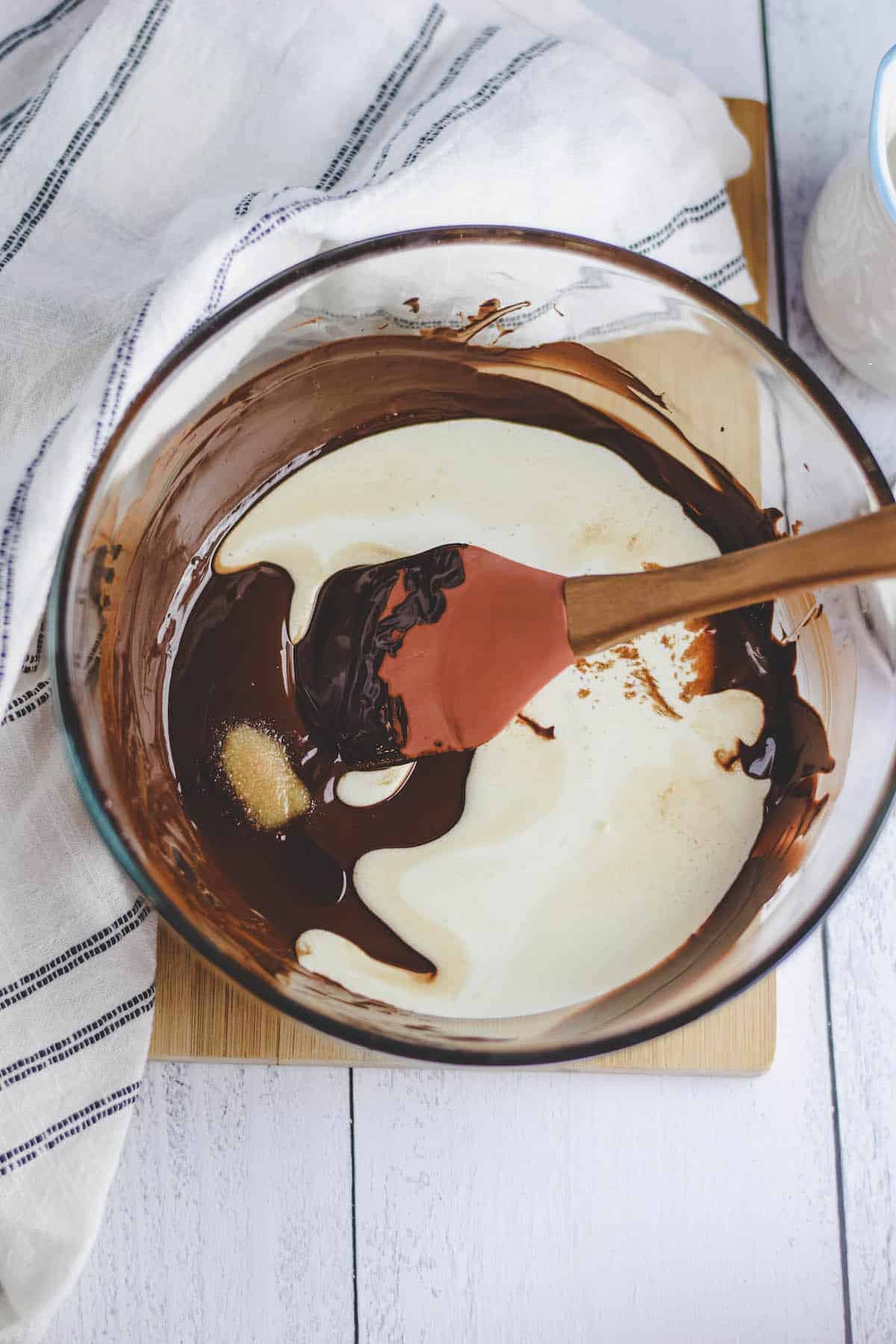 stirring in the heavy cream to the melted chocolate