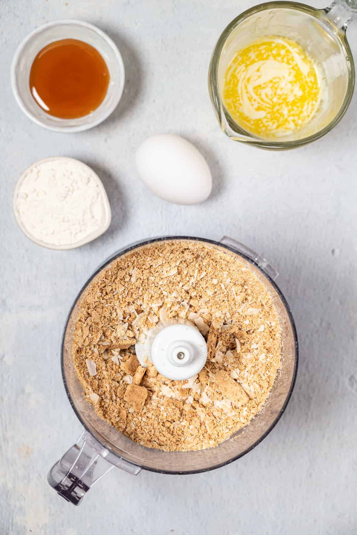 making the coconut and graham cracker crust in the food processor