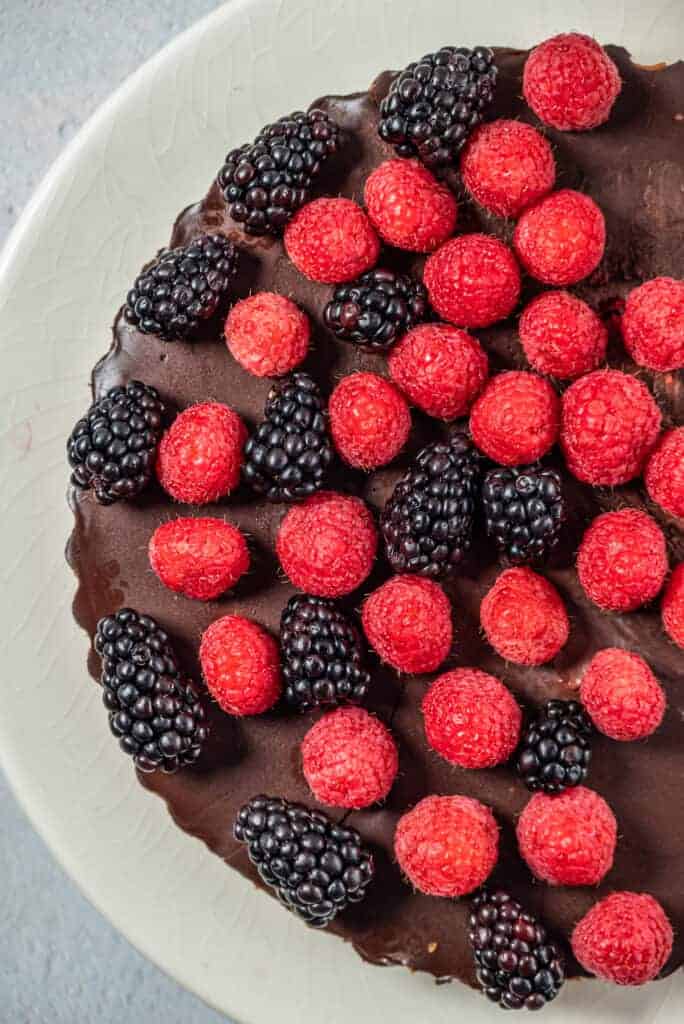 fresh raspberries and blackberries on top of the chocolate tart