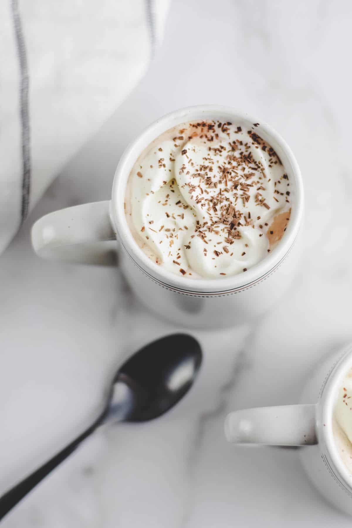 mocha topped with homemade whipped cream and dark chocolate shavings