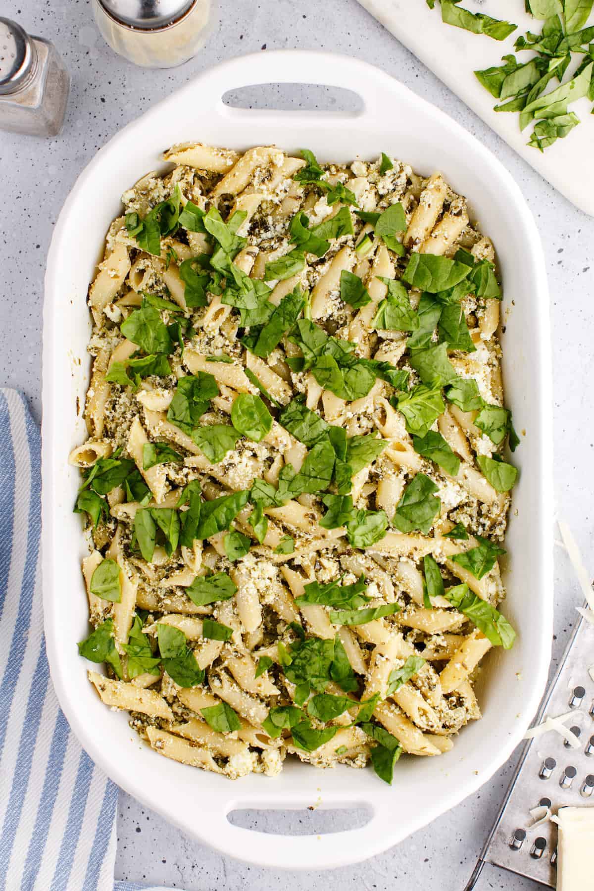 the pasta is topped with chopped spinach