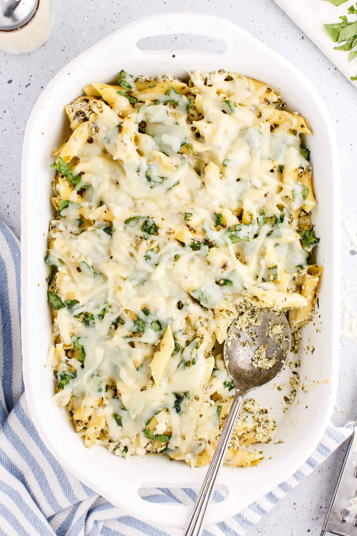 white baking dish filled with the pesto pasta bake