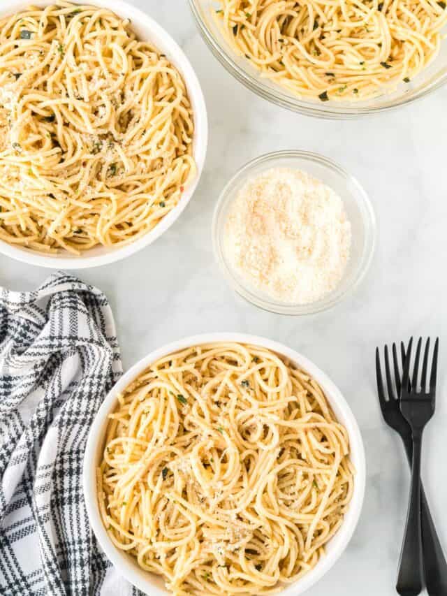 3 white pasta bowls filled with spaghetti aglio e olio
