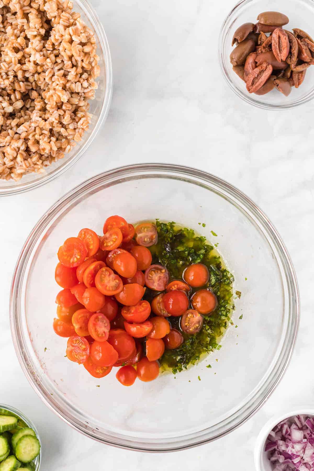 tomatoes in a bowl with the lemon herb dressing.