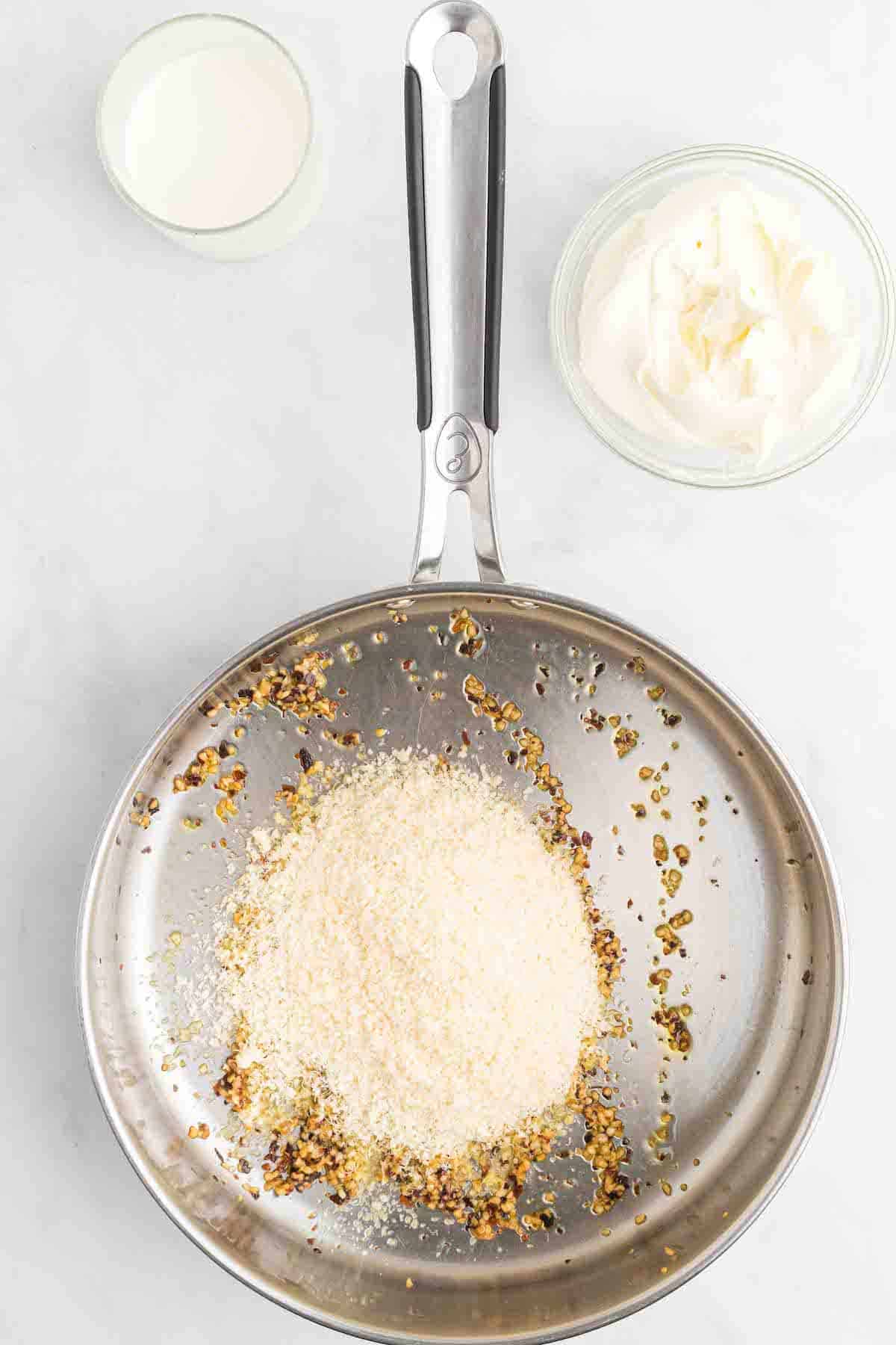 minced garlic, crushed red pepper and parmesan cheese in a large skillet.