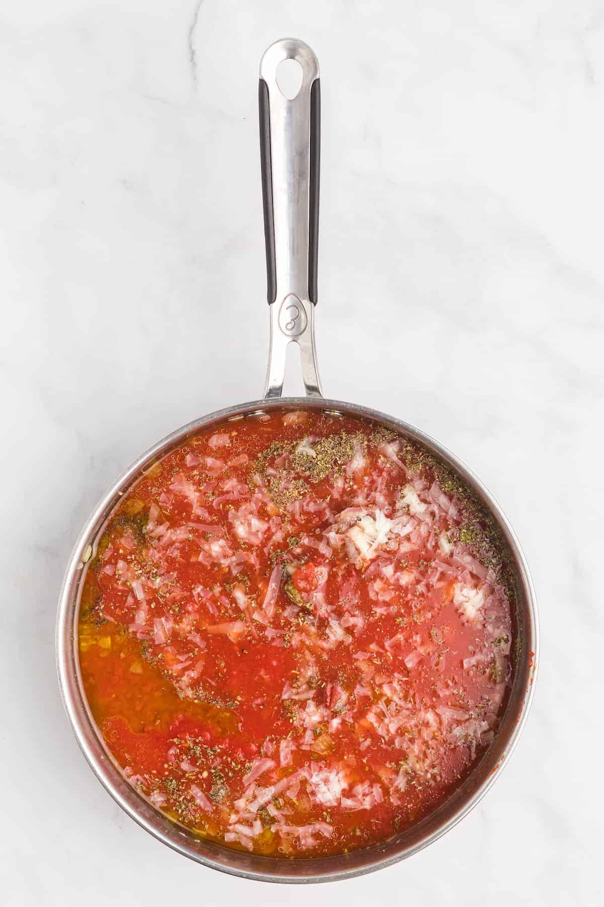 simmering the marinara sauce in the pan.