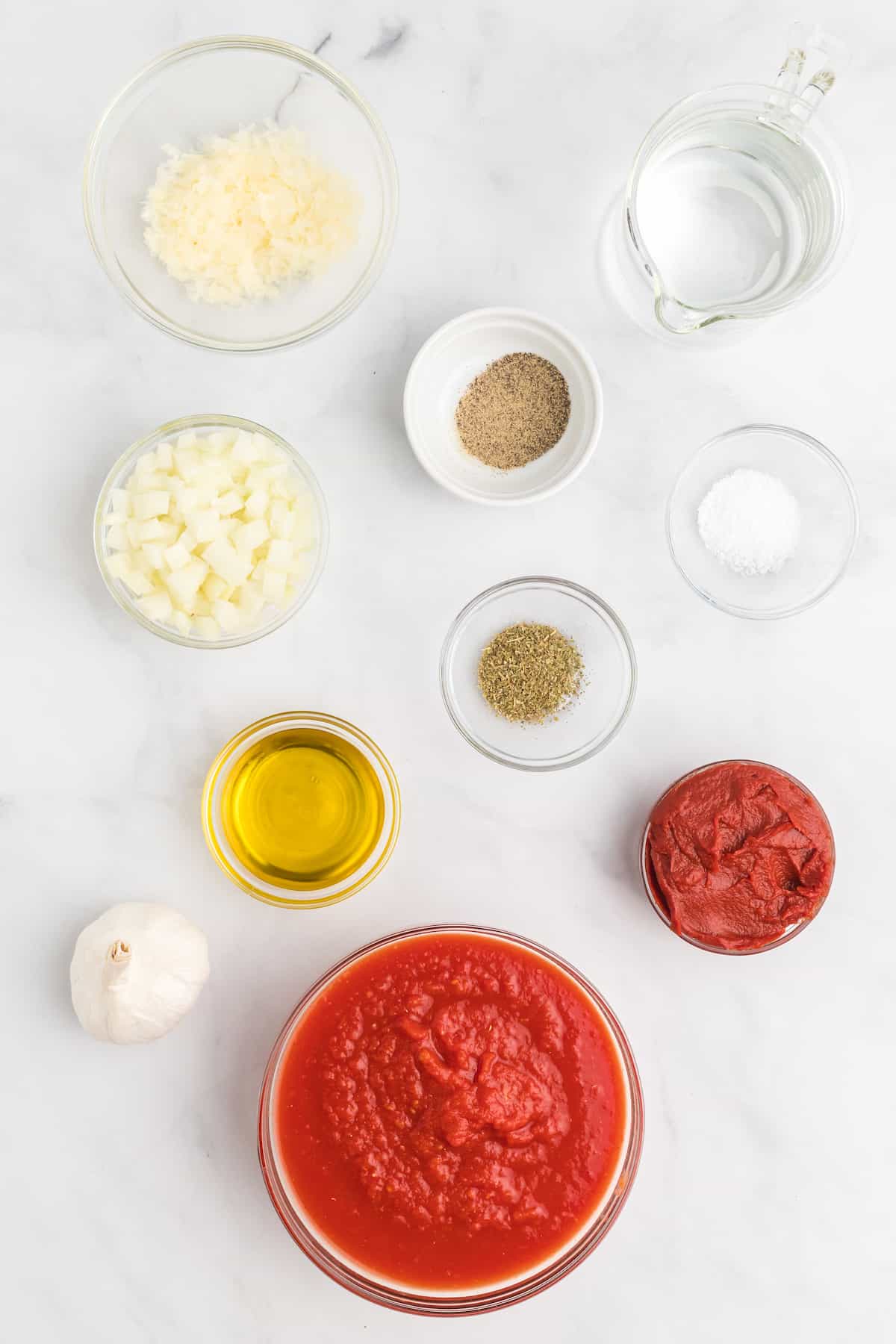 ingredients for the marinara sauce in small glass bowls.