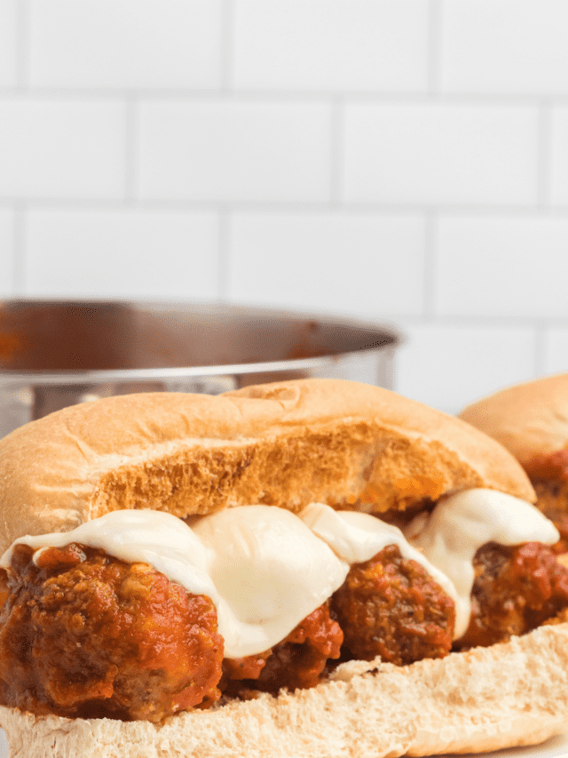 plate with meatball subs and melted mozzarella cheese on top