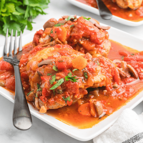 chicken cacciatore with fresh herbs on top.