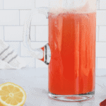 glass pitcher with strawberry lemonade