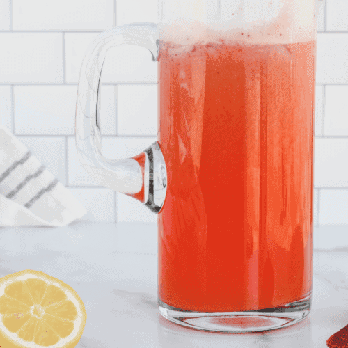 glass pitcher with strawberry lemonade