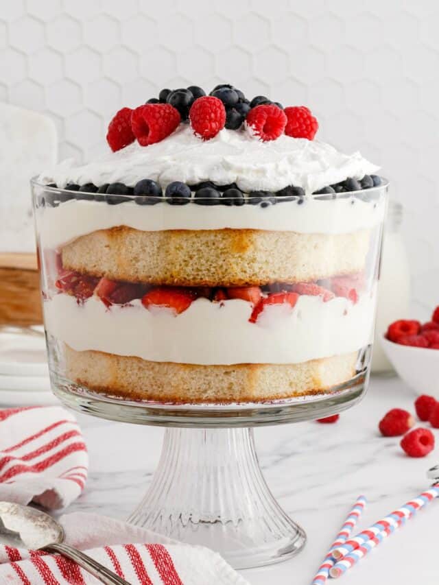 summer berry trifle layered in a glass trifle dish.