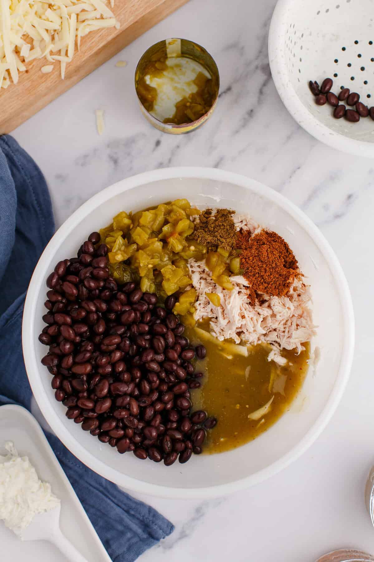 large white bowl with the chiles, sauces, beans, and seasonings.
