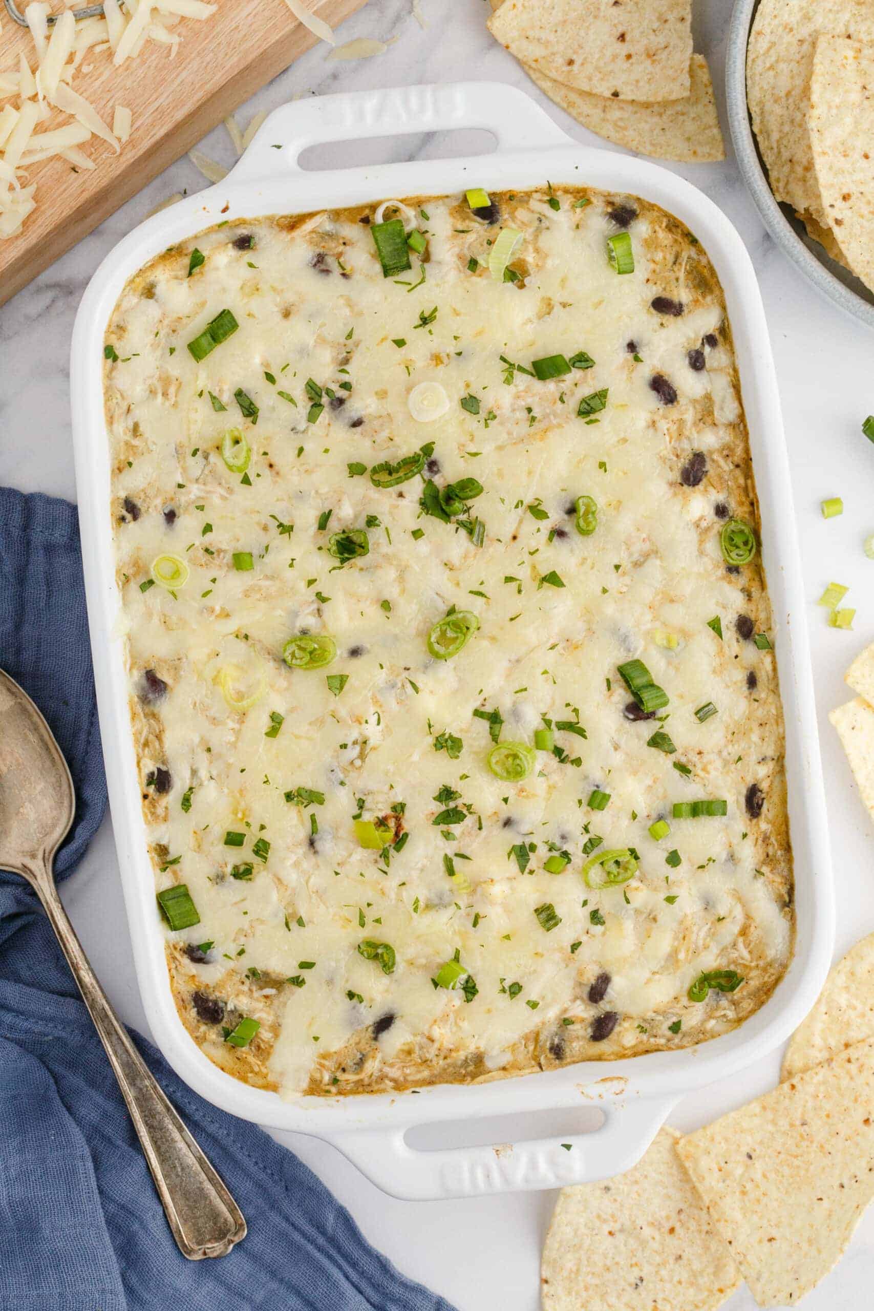white casserole dish with creamy chicken enchilada dip.