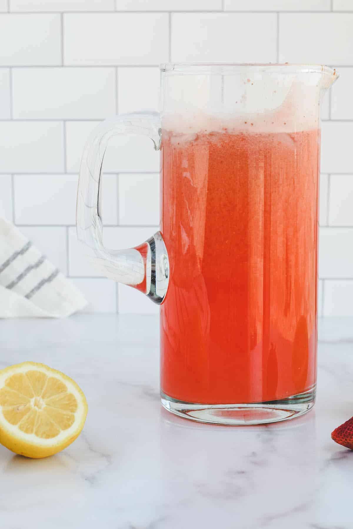 pitcher with combined strawberry lemonade.