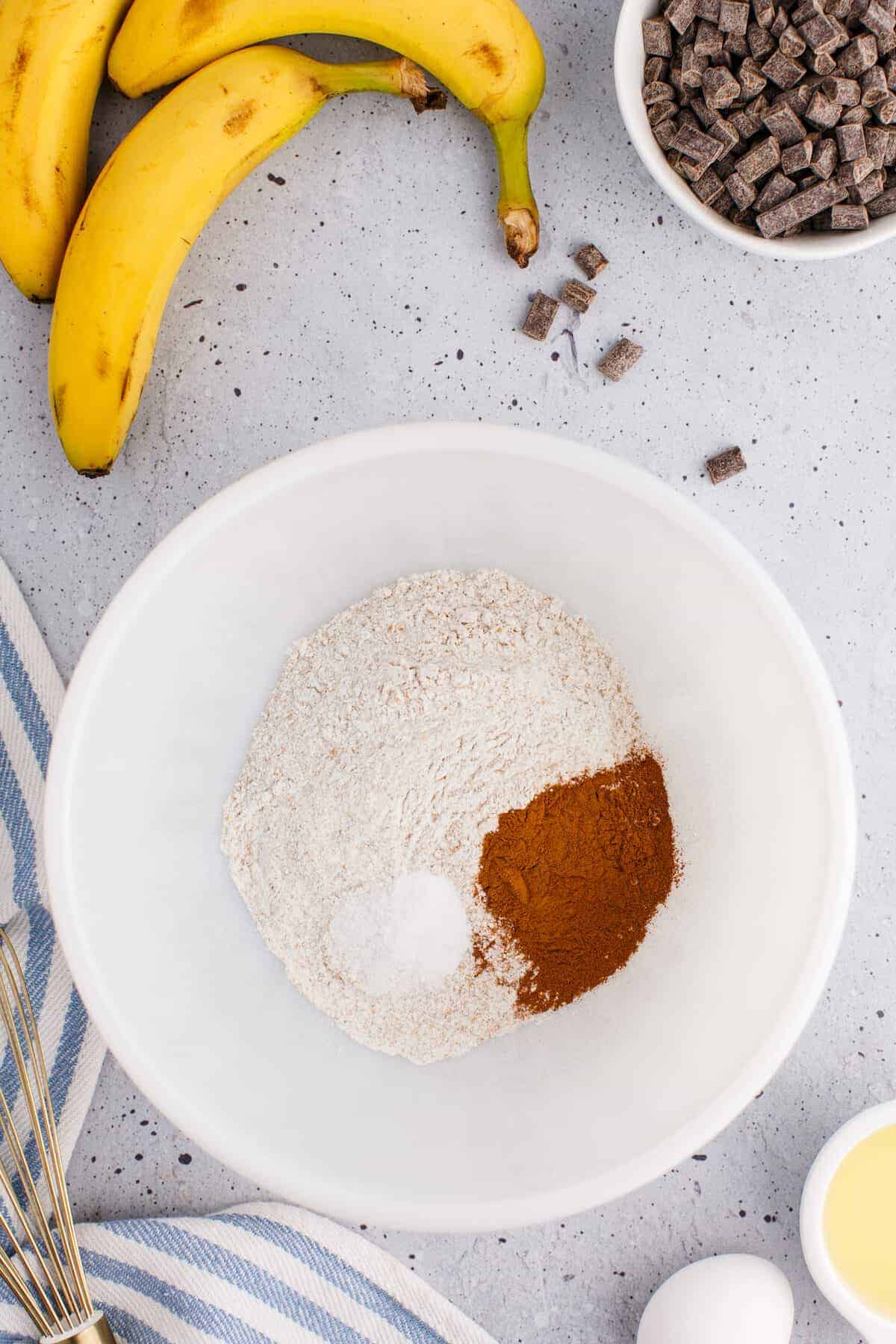 dry ingredients for the banana bread in a large white bowl.