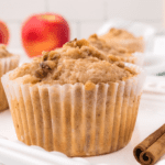 closeup of an apple crumble muffin in a muffin liner.