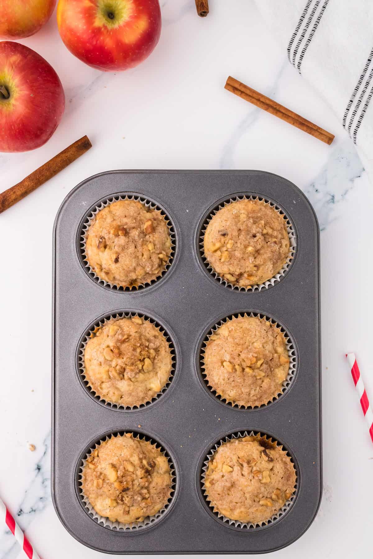 finished apple muffins in a the muffin tin with liners.