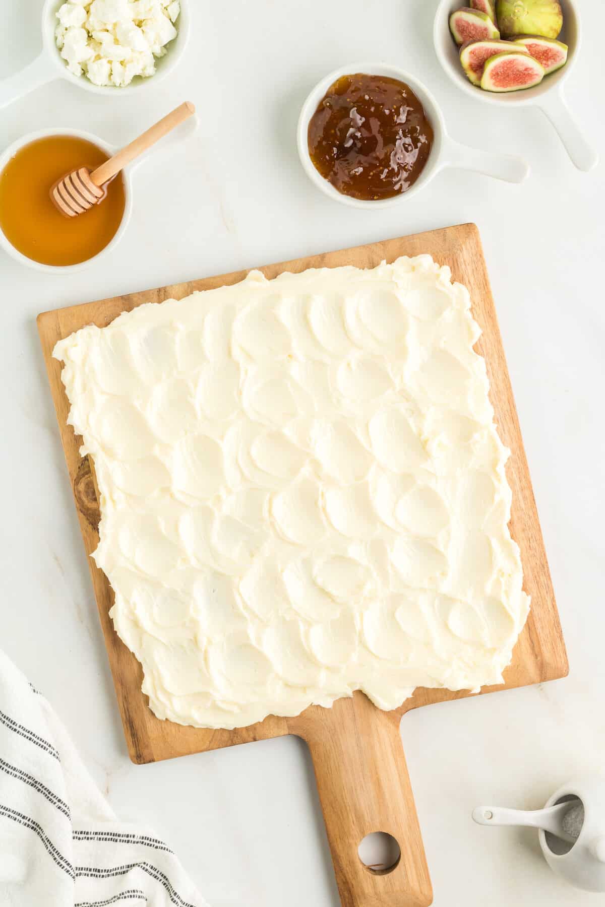 wooden board with softened butter spread over top.