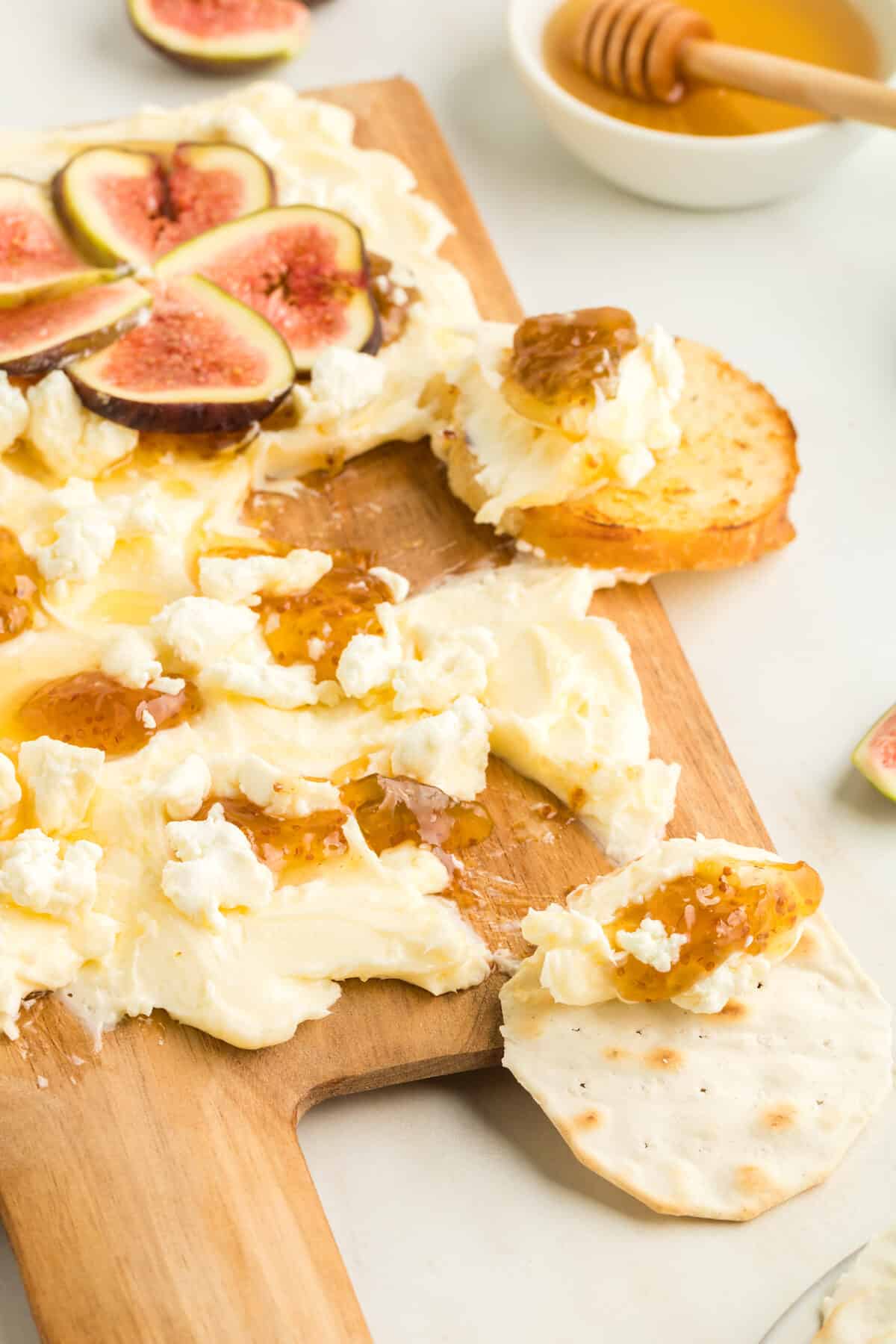 butter board with crusty bread and crackers.