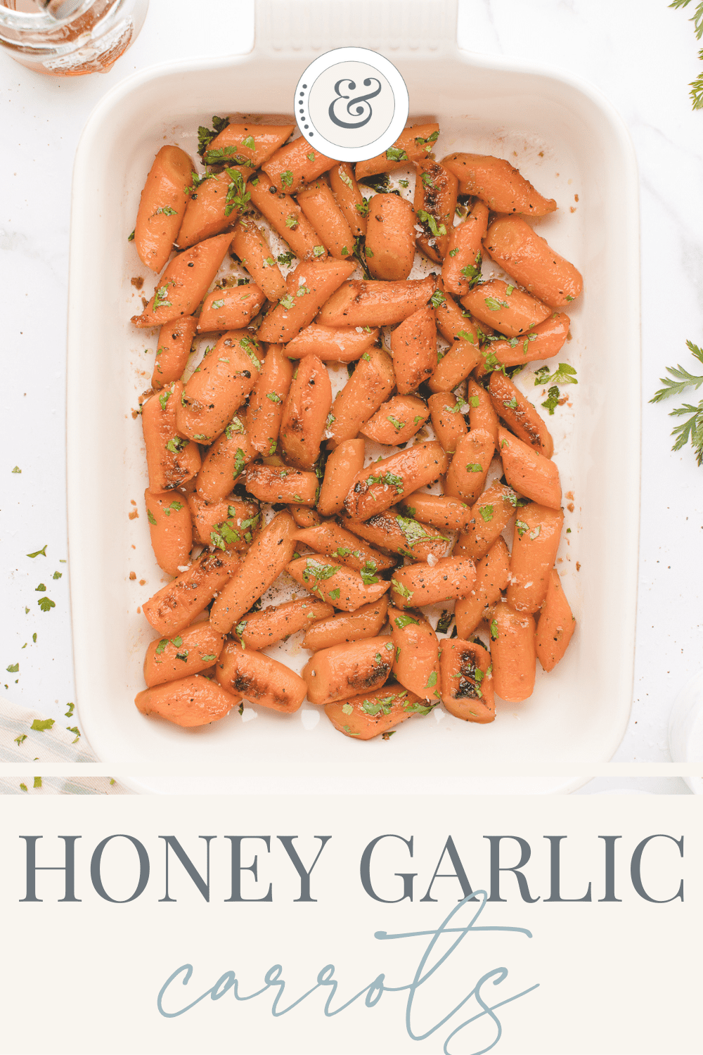 large white platter of finished roasted carrots with honey garlic butter sauce.