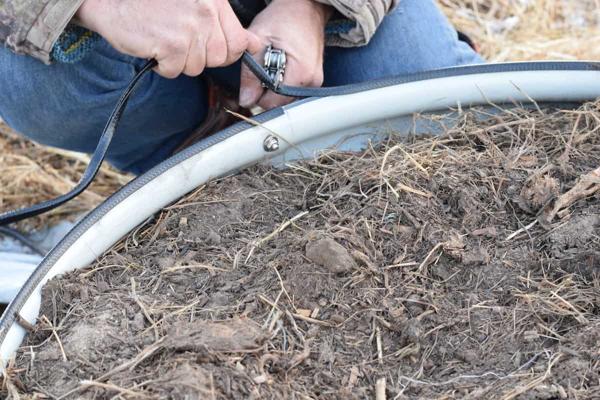 trimming the rubber edging for the raised beds.