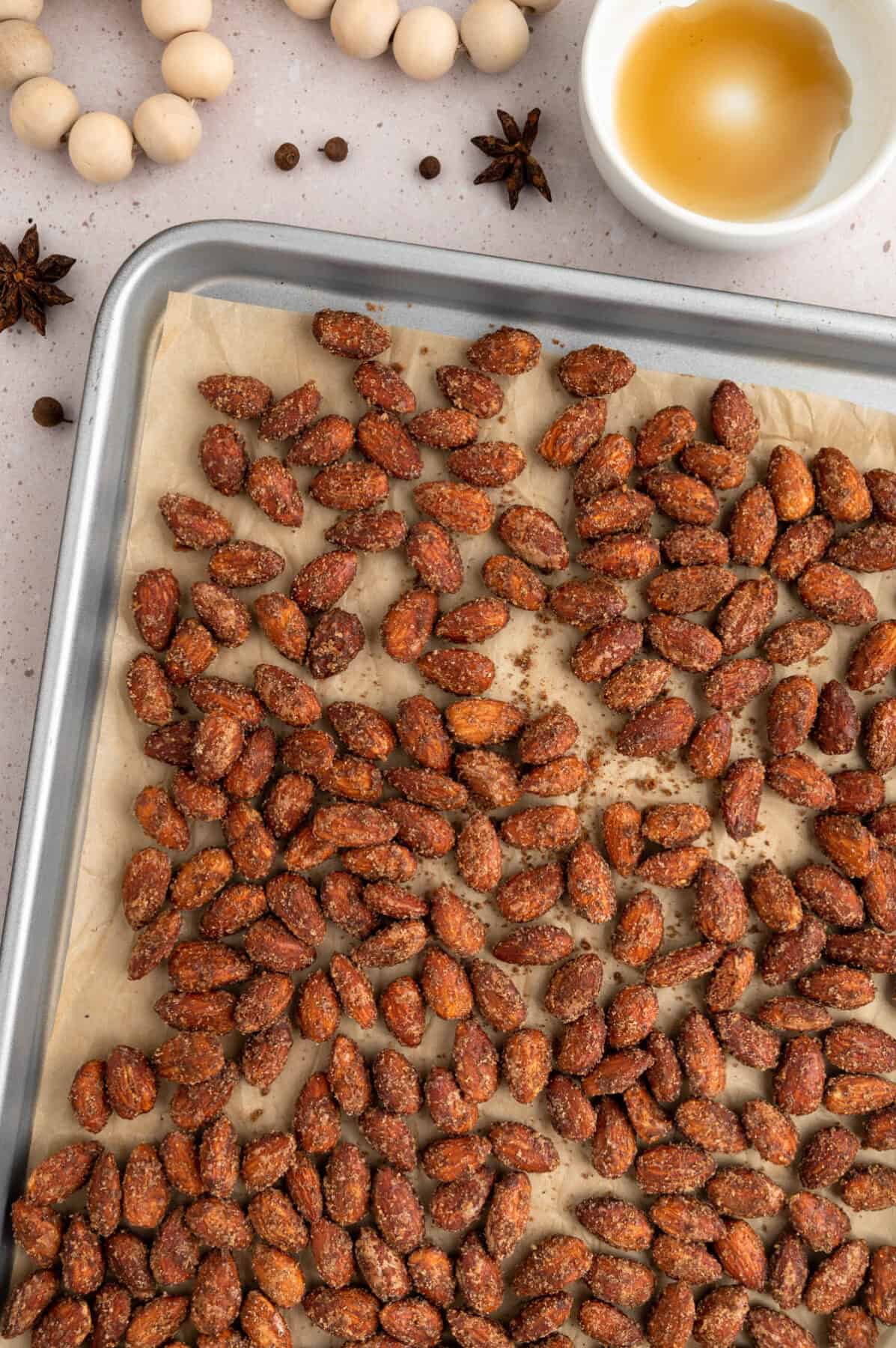 parchment paper lined baking sheet with the spiced almonds. 