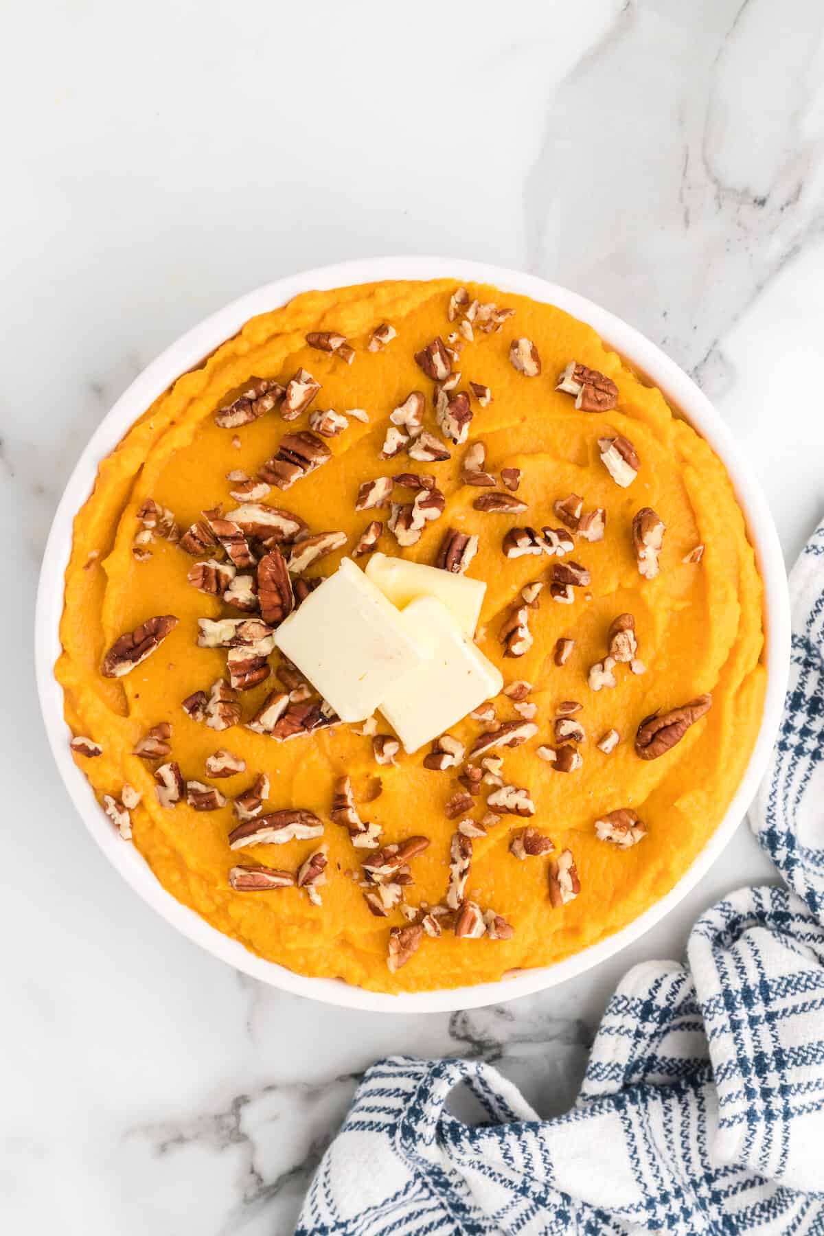 large white serving bowl with healthy mashed sweet potatoes.