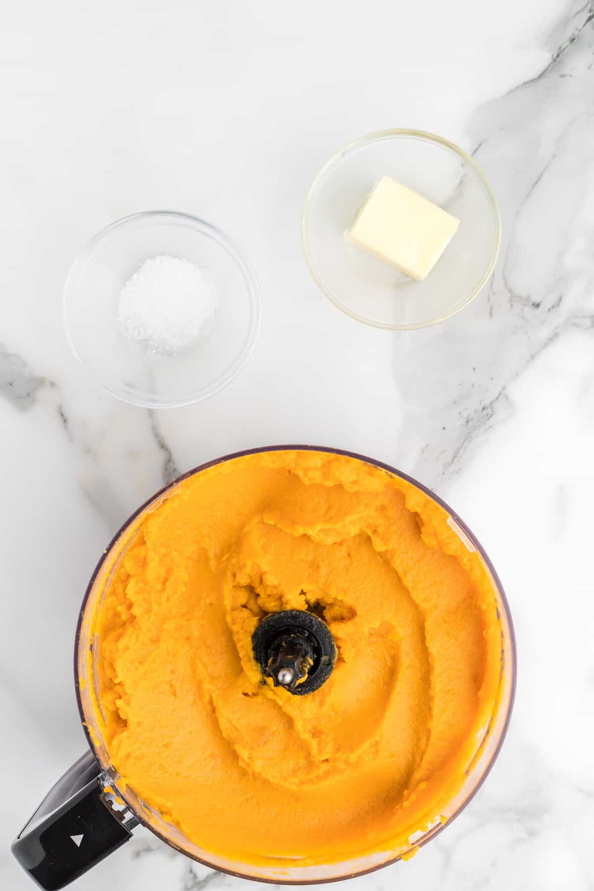 creamy mashed sweet potatoes in a food processor bowl. 