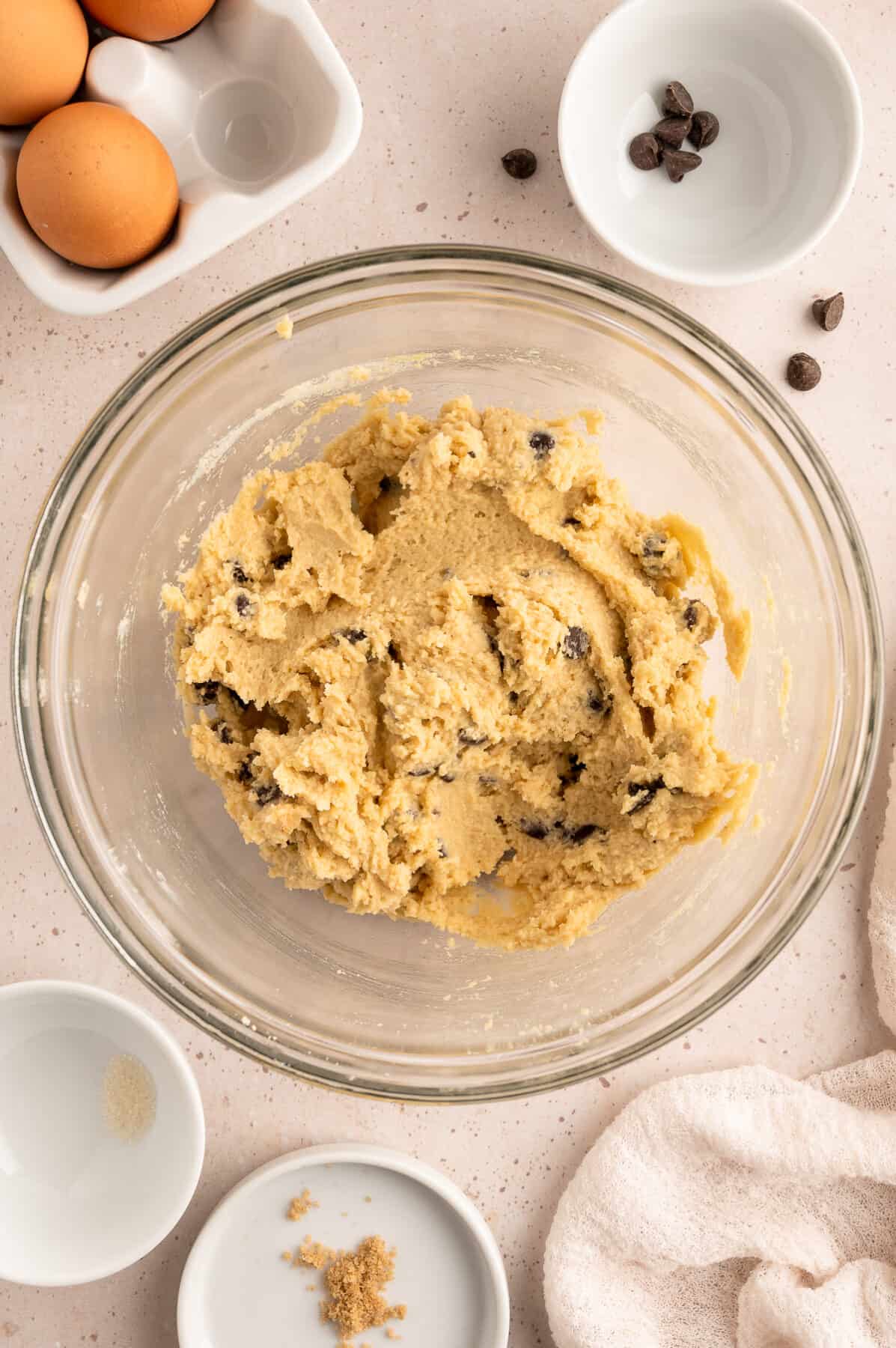 cookie dough in a large glass mixing bowl. 